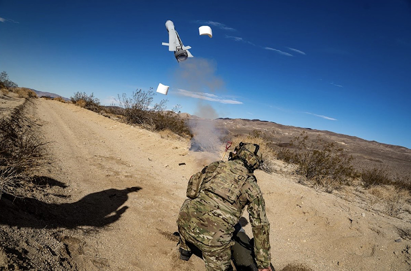 A Special Forces operator launches a live loitering munition to conduct an attack on enemy vehicles that are approaching their location. 